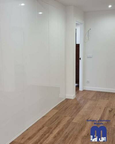 Armario empotrado a medida en un piso de Gijón, diseñado para aprovechar al máximo el espacio con un acabado elegante y funcional.