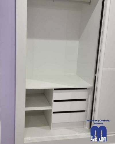 Armario empotrado a medida en un piso de Gijón, diseñado para aprovechar al máximo el espacio con un acabado elegante y funcional.